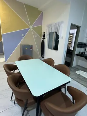 a meeting room with a blue table and chairs at Adik Aisyah cameron homestay quintet A3-7-5 in Tanah Rata