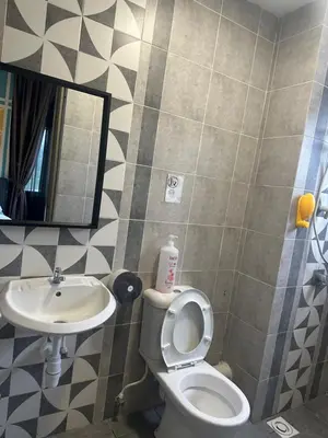 a bathroom with a toilet and a sink and a mirror at Adik Aisyah cameron homestay quintet A3-7-7 in Tanah Rata