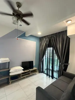 a living room with a couch and a ceiling fan at Adik Aisyah cameron homestay quintet A3-7-7 in Tanah Rata