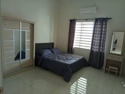 a bedroom with a bed and a large window at Iman4 Homestay in Kampung Behrang