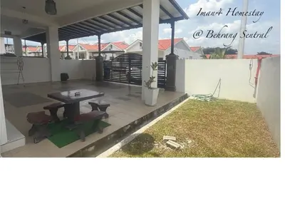 a patio with a table and chairs on a house at Iman4 Homestay in Kampung Behrang