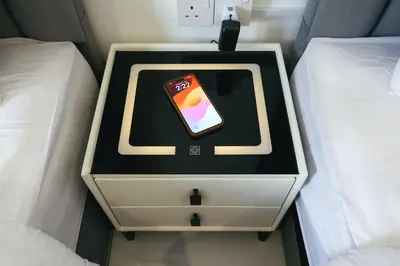 a cell phone sitting on top of a nightstand between two beds at Cameron Centrum Brinchang JoyStay Private Kids Playground Clover Home A-2-15 A in Brinchang