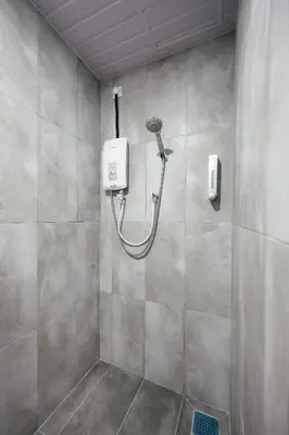 a shower with a hose attached to a wall at Cameron Centrum Brinchang ChillSuites Peaceful Escape Clover Home A-3-15B in Brinchang