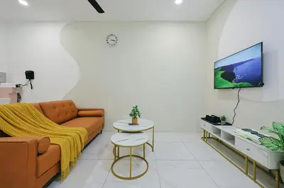 a living room with a couch and a tv at Cameron Centrum Brinchang ChillSuites Peaceful Escape Clover Home A-3-15B in Brinchang