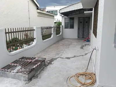 a porch of a house with a hose at 50 Canning Garden Homestay in Ipoh