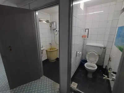 a bathroom with a toilet and a sink at 50 Canning Garden Homestay in Ipoh