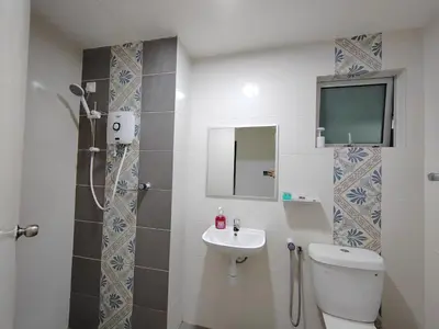 a bathroom with a toilet and a sink and a shower at Ipoh Anderson Suites in Ipoh