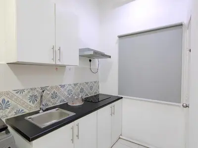 a kitchen with white cabinets and a sink at Ipoh Anderson Suites in Ipoh