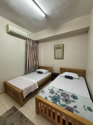 a bedroom with two beds and a window at ANHAAZ Lakefront Retreat in Kampong Balek Bukit
