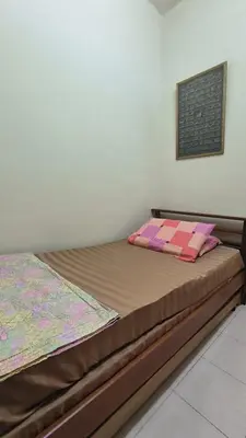 a bedroom with a bed in a room at ANHAAZ Lakefront Retreat in Kampong Balek Bukit