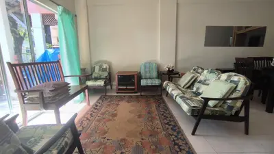 a living room with chairs and a couch and a rug at ANHAAZ Lakefront Retreat in Kampong Balek Bukit
