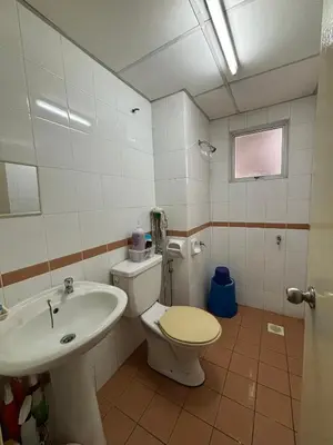 a bathroom with a toilet and a sink at ANHAAZ Lakefront Retreat in Kampong Balek Bukit