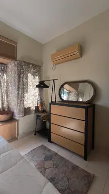 a bedroom with a dresser with a mirror and a bed at ANHAAZ Lakefront Retreat in Kampong Balek Bukit