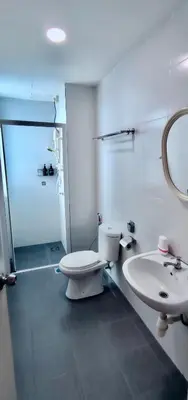 a bathroom with a toilet and a sink at Rainy Sanctuary Homestay With Netflix - 1 Parking in Taiping
