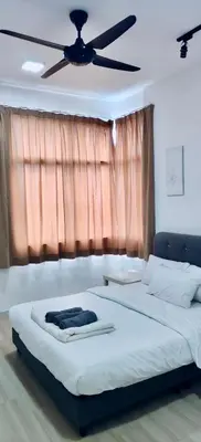 a bedroom with two beds and a ceiling fan at Rainy Sanctuary Homestay With Netflix - 1 Parking in Taiping
