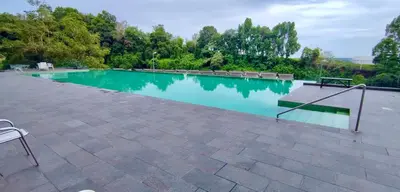 a swimming pool with a bench in the middle at Rainy Sanctuary Homestay With Netflix - 1 Parking in Taiping