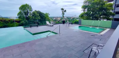 a swimming pool on top of a building at Rainy Sanctuary Homestay With Netflix - 1 Parking in Taiping