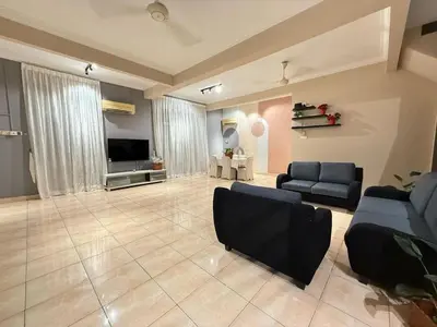 a large living room with couches and a television at Relax Guest House Taman Merak Jaya Simpang Ampat in Simpang Ampat