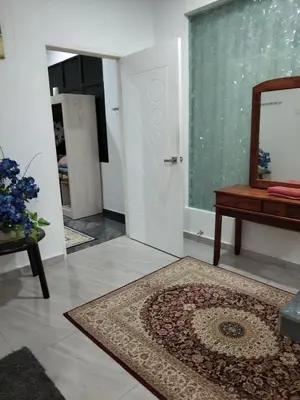 a room with a mirror and a door and a rug at Makwan Homestay B in Kubang Semang