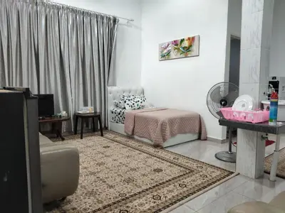 a living room with a bed and a couch at Makwan Homestay B in Kubang Semang