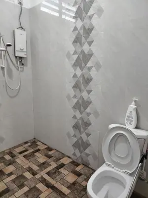 a bathroom with a toilet and a shower at Makwan Homestay B in Kubang Semang