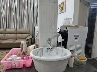 a bathroom with a bath tub with a sink at Makwan Homestay B in Kubang Semang