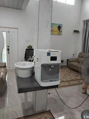 a kitchen with a machine on a table in a living room at Makwan Homestay B in Kubang Semang