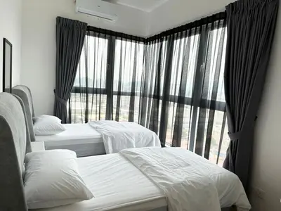 a bedroom with three beds and a large window at ICC Suites Ipoh 16th floor in Ipoh