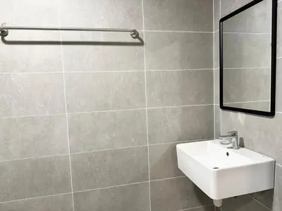 a bathroom with a white sink and a mirror at ICC Suites Ipoh 16th floor in Ipoh