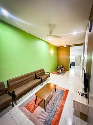 a living room with a couch and a tv at Sofea Homestay Raban Lake in Kampong Kuala Chegar