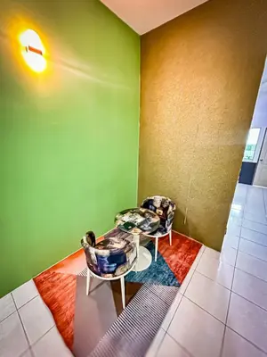 a room with two chairs and a table at Sofea Homestay Raban Lake in Kampong Kuala Chegar