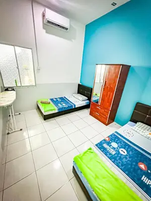 a room with two beds in a room at Sofea Homestay Raban Lake in Kampong Kuala Chegar