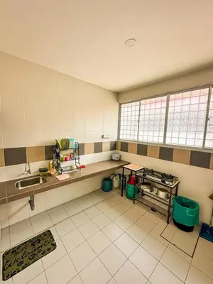 a kitchen with a sink and a counter in a room at Sofea Homestay Raban Lake in Kampong Kuala Chegar