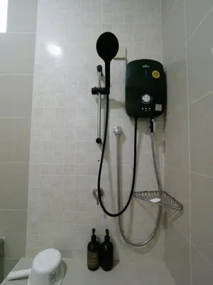 a shower in a bathroom with a black shower head at D SeBalik Pulau Tropical Boutique Home in Balik Pulau