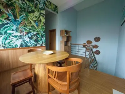 a dining room with a wooden table and chairs at D SeBalik Pulau Tropical Boutique Home in Balik Pulau