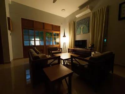 a living room with couches and a coffee table at D SeBalik Pulau Tropical Boutique Home in Balik Pulau