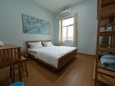 a bedroom with a bed and a window at D SeBalik Pulau Tropical Boutique Home in Balik Pulau
