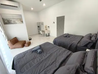 a living room with two beds and a couch at Spacious, 2 Storey Home, Up to 12 Pax, 4 Bedrooms, 4 Bathrooms, 2 Car Park Lots by Star Home in Sungai Petani