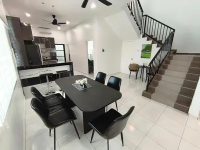 a dining room and kitchen with a table and chairs at Spacious, 2 Storey Home, Up to 12 Pax, 4 Bedrooms, 4 Bathrooms, 2 Car Park Lots by Star Home in Sungai Petani