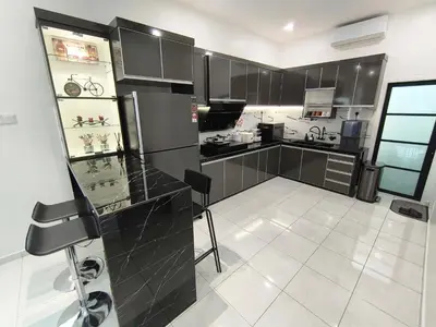 a kitchen with black cabinets and a white tile floor at Spacious, 2 Storey Home, Up to 12 Pax, 4 Bedrooms, 4 Bathrooms, 2 Car Park Lots by Star Home in Sungai Petani