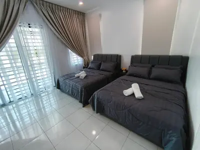 a bedroom with two beds and a window at Spacious, 2 Storey Home, Up to 12 Pax, 4 Bedrooms, 4 Bathrooms, 2 Car Park Lots by Star Home in Sungai Petani