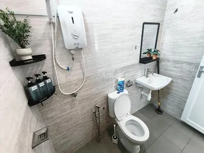 a bathroom with a shower and a toilet and a sink at Spacious, 2 Storey Home, Up to 12 Pax, 4 Bedrooms, 4 Bathrooms, 2 Car Park Lots by Star Home in Sungai Petani