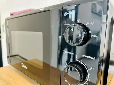 a close up of a toaster oven on a table at Comfort Stay Family Home 3BR-10PAX b30 in George Town