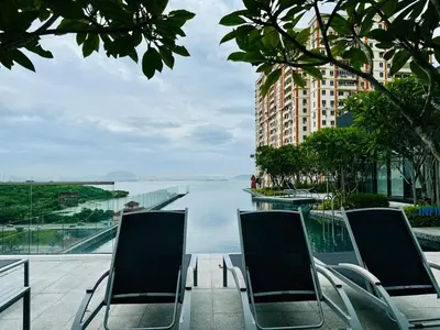 a group of chairs sitting next to a body of water at Cozy Sea & City View Penang, 3BR-10PAX b30 in George Town
