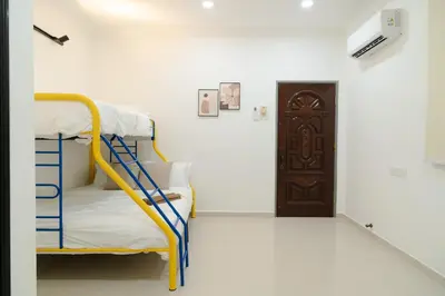 a room with two bunk beds and a door at Bm16 16pax4b3b in Bukit Mertajam