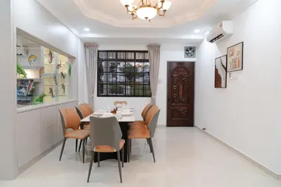 a dining room with a table and chairs and a window at Bm16 16pax4b3b in Bukit Mertajam