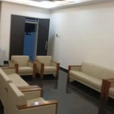 a waiting room with couches and chairs in a room at mulia homestay in Teluk Intan