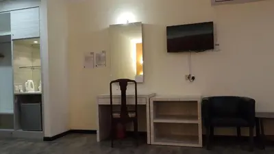 a room with a desk and a television on the wall at Red Rock Hotel Penang in George Town