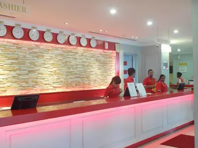 a group of people standing at a counter in a restaurant at Red Rock Hotel Penang in George Town