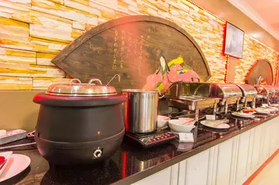 a kitchen with a counter with pots and pans at Red Rock Hotel Penang in George Town